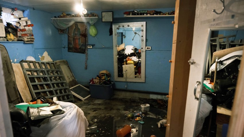 A flooded basement level apartment stands in a Queens neighborhood