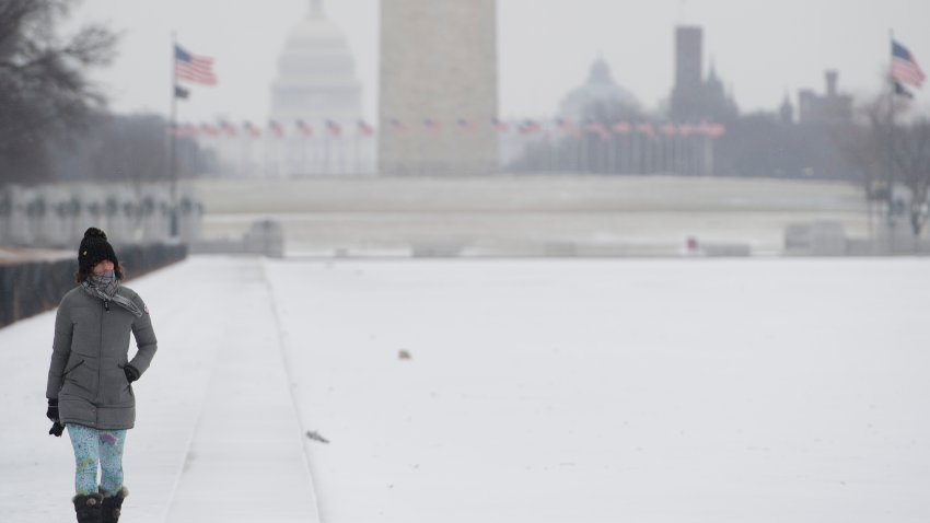 People walk alongside a frozen Lincoln Memorial Reflecting Pool on the National Mall during a snow storm in Washington, DC, January 4, 2018.
A giant winter “bomb cyclone” walloped the US East Coast on Thursday with freezing cold and heavy snow, forcing thousands of flight cancellations and widespread school closures — and even prompting the US Senate to cancel votes for the rest of the week.Millions of Americans faced potential power outages in bitterly cold sub-freezing temperatures, with some 45,000 people in Virginia and thousands more in Georgia, South Carolina and Florida already affected.
 / AFP PHOTO / SAUL LOEB        (Photo credit should read SAUL LOEB/AFP via Getty Images)